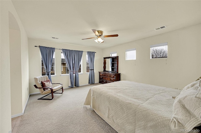 bedroom featuring ceiling fan and light carpet