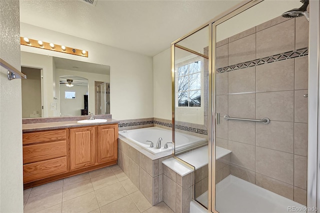 bathroom with shower with separate bathtub, vanity, tile patterned floors, and ceiling fan