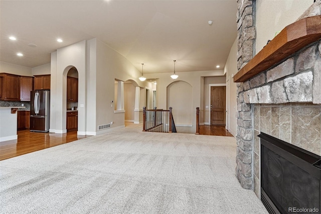 living room with carpet and a fireplace