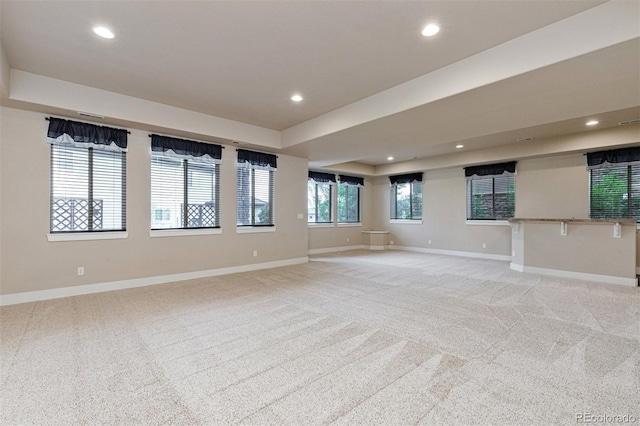 unfurnished living room featuring light colored carpet