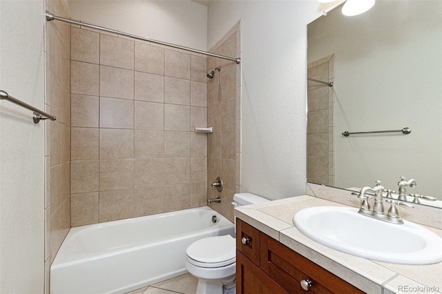 full bathroom featuring toilet, tile patterned flooring, tiled shower / bath combo, and vanity