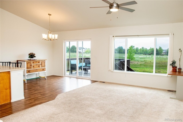 1766 Country Sun Dr, Windsor, CO 80550 - carpeted empty room with vaulted ceiling, a chandelier, a ceiling fan, and wood finished floors