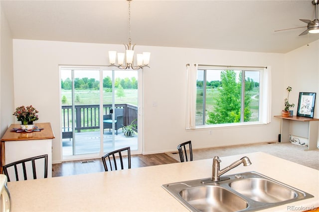 1766 Country Sun Dr, Windsor, CO 80550 - kitchen with a ceiling fan, light countertops, a chandelier, and hanging light fixtures