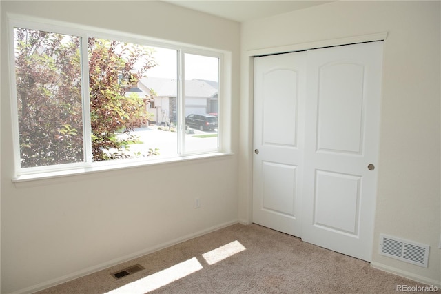 1766 Country Sun Dr, Windsor, CO 80550 - unfurnished bedroom with light carpet, multiple windows, and a closet