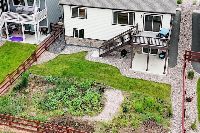 1766 Country Sun Dr, Windsor, CO 80550 - back of property featuring a patio area, stairway, a fenced backyard, and a deck
