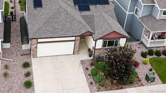 1766 Country Sun Dr, Windsor, CO 80550 - view of front facade with a shingled roof, stone siding, and an attached garage