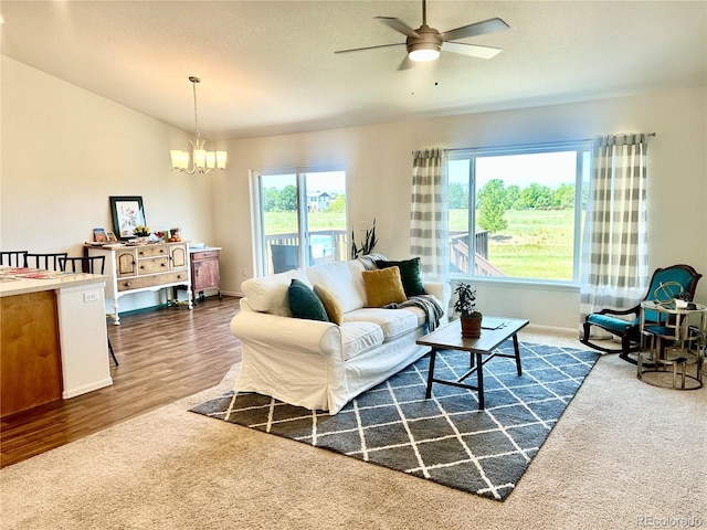1766 Country Sun Dr, Windsor, CO 80550 - living room with a ceiling fan, a chandelier, and dark wood finished floors
