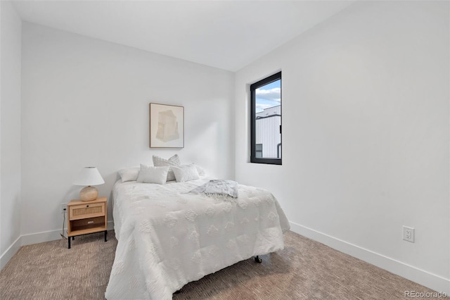 bedroom featuring carpet floors and baseboards