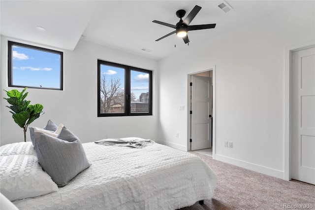 carpeted bedroom with baseboards, visible vents, and ceiling fan