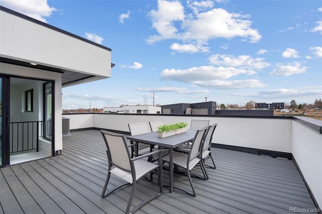 wooden deck with outdoor dining space and cooling unit