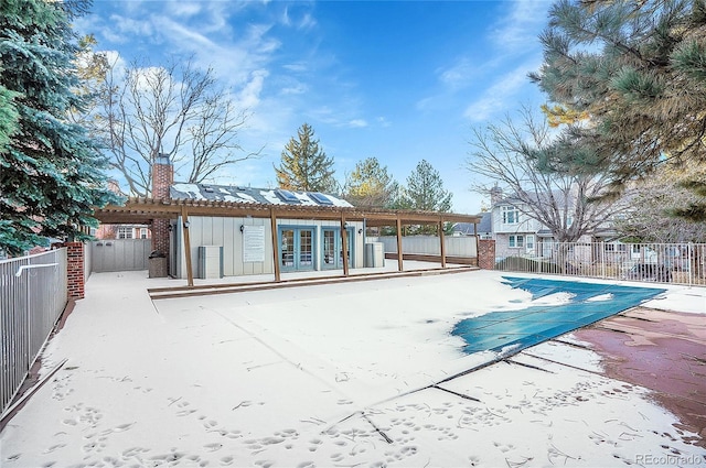 rear view of property featuring a pergola, a patio area, and a covered pool