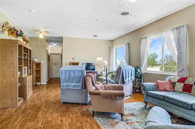 living room with hardwood / wood-style flooring and ceiling fan