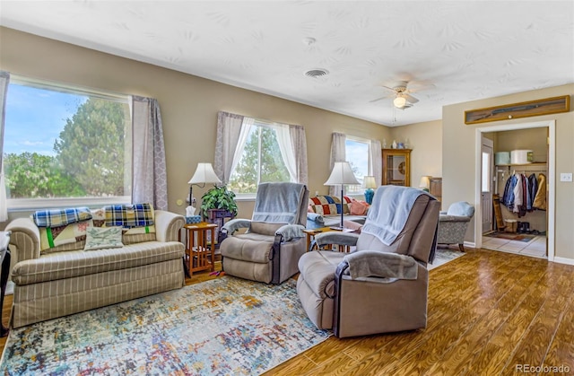 living room with light hardwood / wood-style floors and ceiling fan