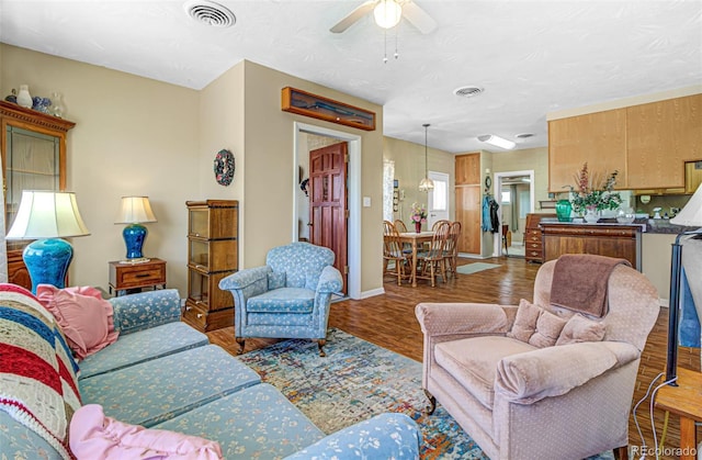 living room with hardwood / wood-style floors and ceiling fan