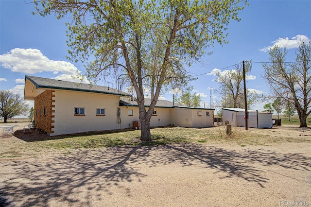 view of home's exterior with a jacuzzi