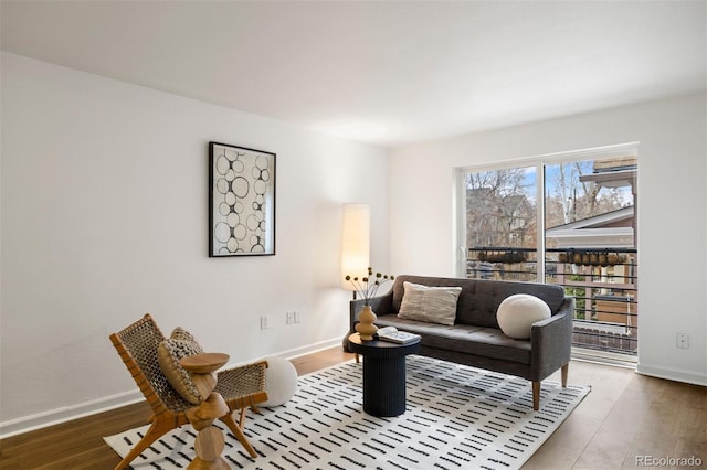 living room with baseboards and wood finished floors