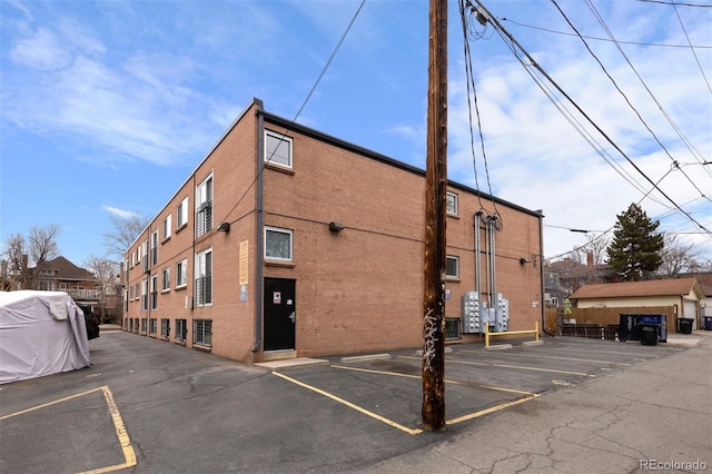 view of building exterior with uncovered parking