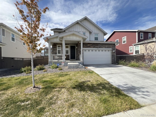 view of front of property with a porch, a front lawn, and a garage