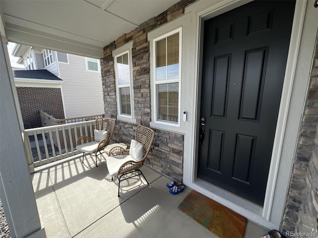 view of exterior entry with covered porch