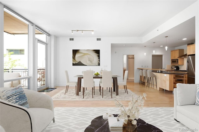 living room featuring light wood finished floors and baseboards