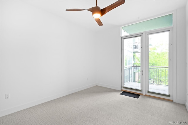 unfurnished room with carpet floors, baseboards, and ceiling fan