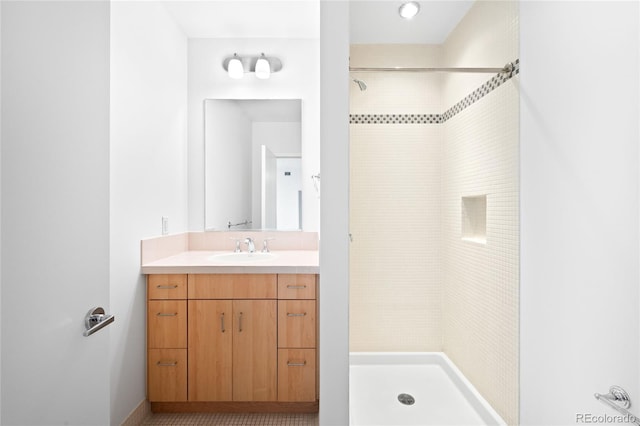 full bathroom with a stall shower and vanity