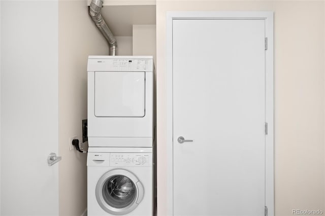 clothes washing area with stacked washer and clothes dryer