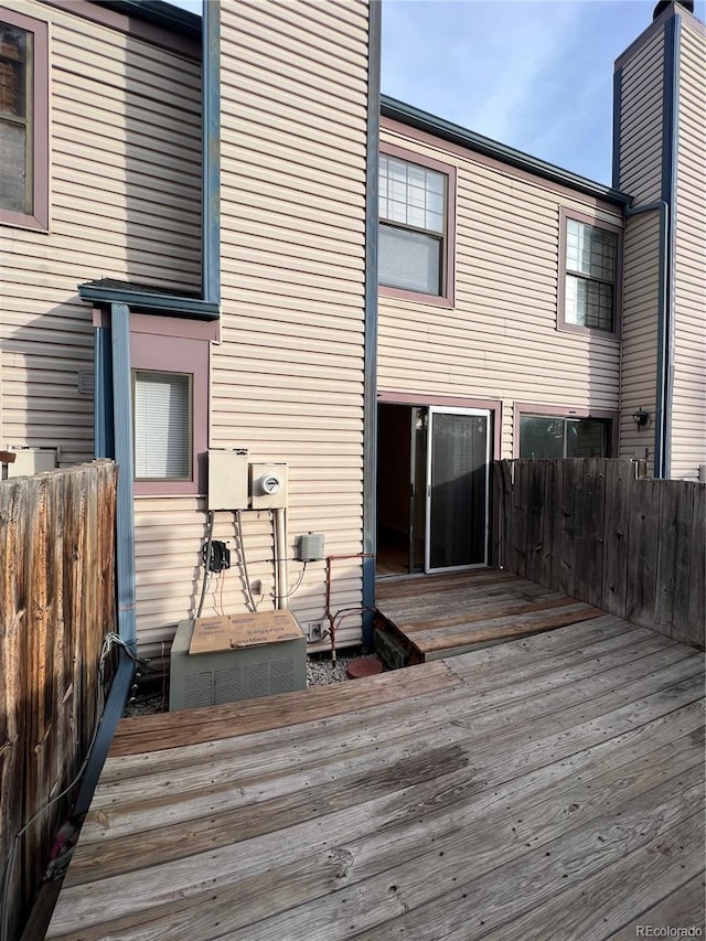 rear view of property featuring a wooden deck