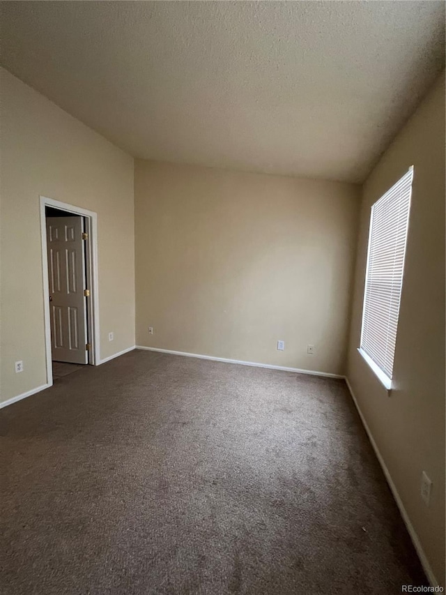 carpeted spare room with a textured ceiling