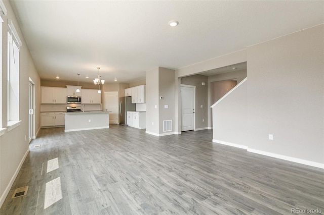 unfurnished living room featuring hardwood / wood-style flooring