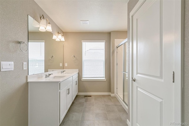 bathroom with vanity, tile patterned flooring, and a shower with door