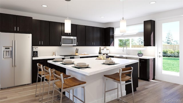 kitchen featuring pendant lighting, stainless steel appliances, a kitchen breakfast bar, and decorative backsplash