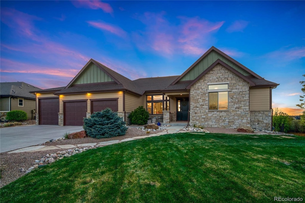 craftsman-style home featuring board and batten siding, stone siding, and a yard