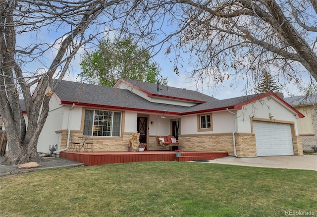 view of front of home with a front lawn, concrete driveway, an attached garage, stone siding, and stucco siding