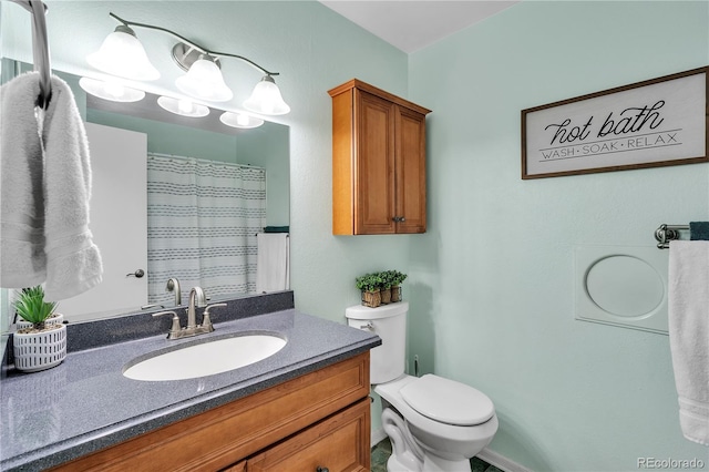 bathroom with vanity, a shower with shower curtain, and toilet