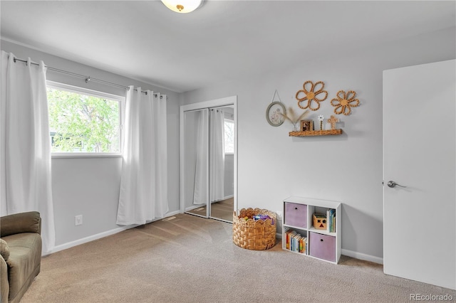 interior space with baseboards, carpet, and a healthy amount of sunlight