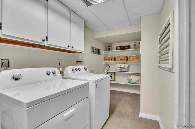 clothes washing area featuring cabinet space, separate washer and dryer, baseboards, and light carpet