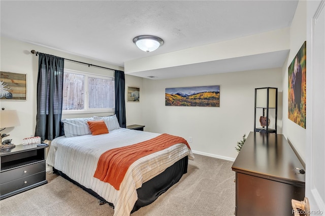 carpeted bedroom featuring baseboards
