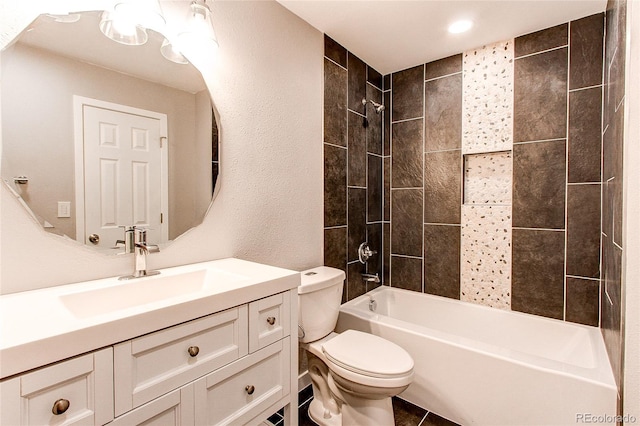 full bathroom with tile patterned flooring, vanity, toilet, and tiled shower / bath