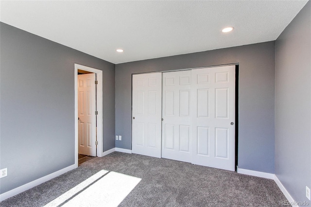 unfurnished bedroom featuring carpet flooring and a closet