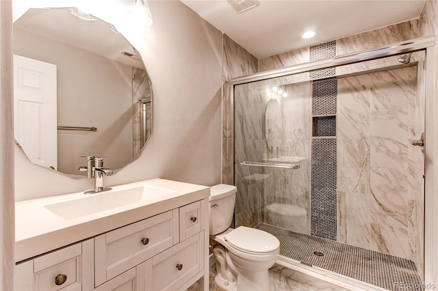 bathroom with vanity, toilet, tile patterned floors, and a shower with door