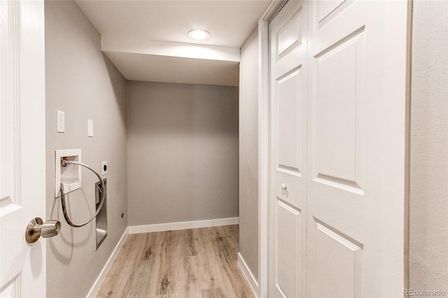 clothes washing area featuring light hardwood / wood-style flooring, hookup for an electric dryer, and washer hookup