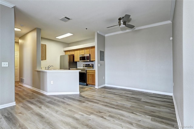 kitchen with ceiling fan, ornamental molding, stainless steel appliances, and light hardwood / wood-style floors