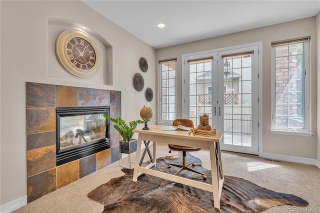 office with baseboards, a tiled fireplace, recessed lighting, french doors, and carpet