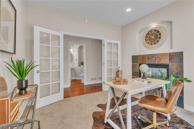 office space with french doors, carpet flooring, baseboards, and visible vents