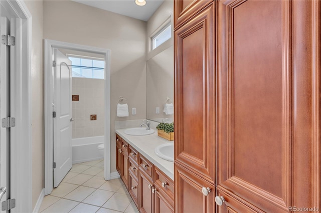 bathroom with double vanity, plenty of natural light, a sink, and tile patterned flooring