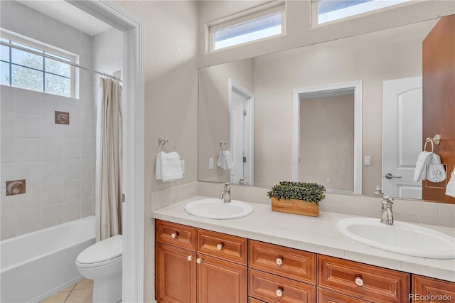 full bathroom with double vanity, toilet, a sink, and shower / tub combo