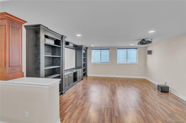 unfurnished living room with baseboards, recessed lighting, and wood finished floors