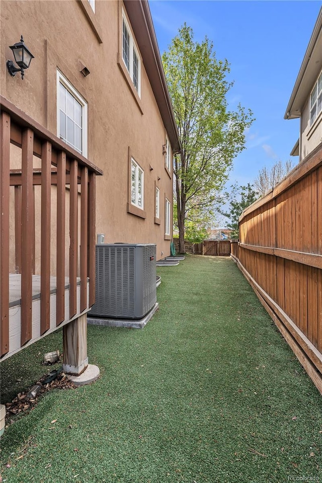 view of yard featuring a fenced backyard and central AC unit