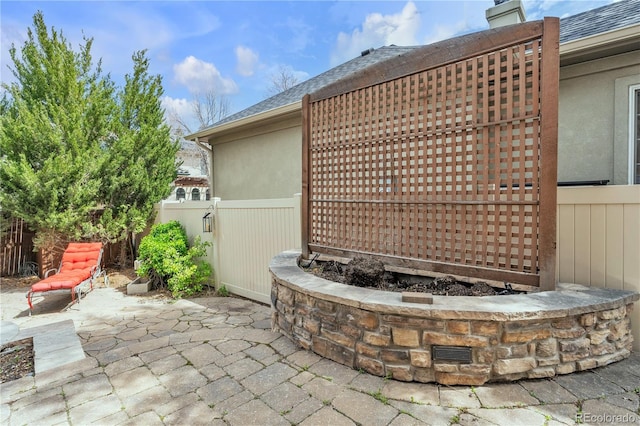 exterior details with stucco siding and fence